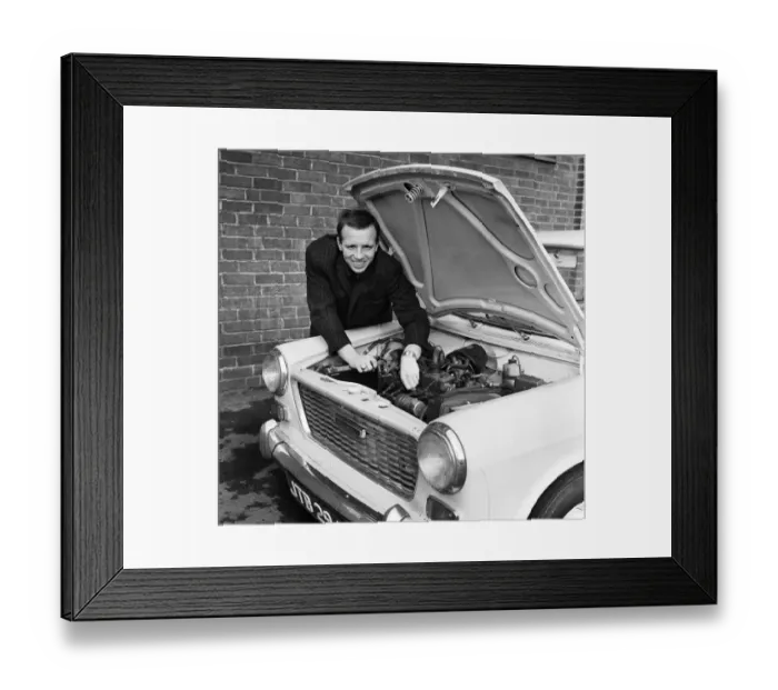 Framed Print : Manchester United and England footballer Nobby Stiles tends to his car engine at Old