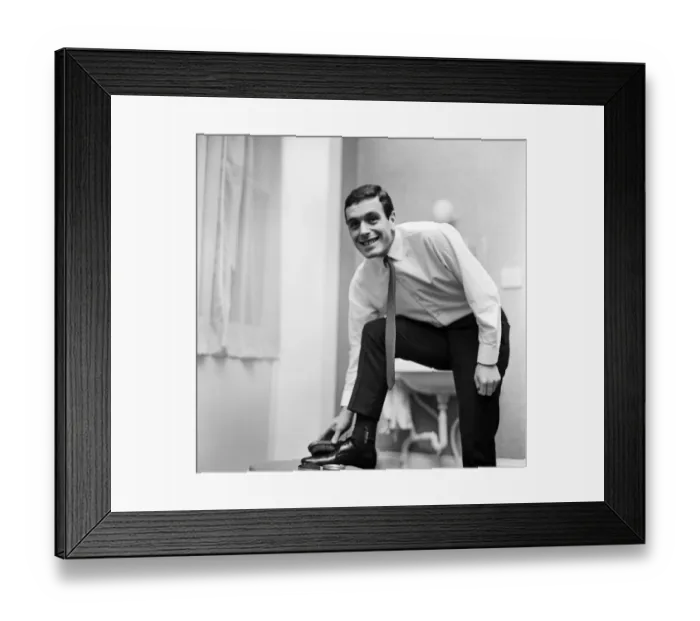 Framed Print : Liverpool and England footballer Ian Callaghan polishes his shoes ahead of his side