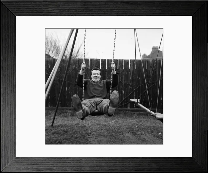 Framed Print : West Ham footballer Johnny Byrne celebrates his England call up with a swing in the back