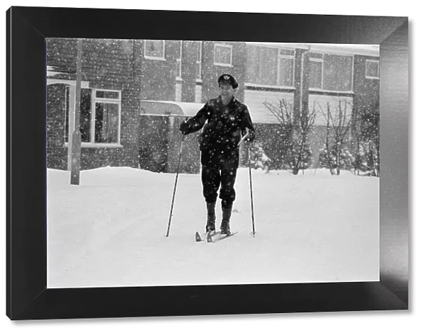 A postman on skis in the snow, Reading, Berkshire. January 1982