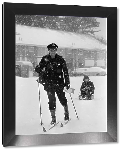A postman on skis in the snow, Reading, Berkshire. January 1982
