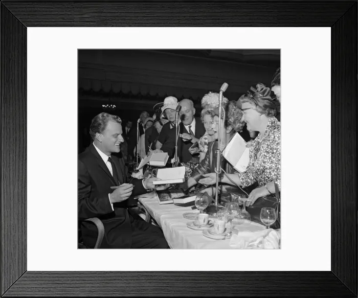 Framed Print : Billy Graham signs copies of his book World Aflame Framed Print : Billy Graham signs copies of his book World Aflame