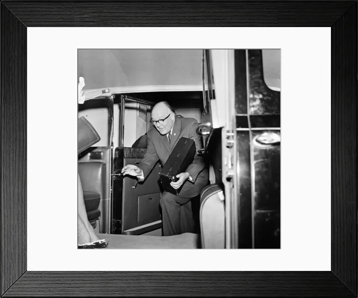 Framed Print : Secretary of the Football Association Denis Follows carries the Jules Rimet trophy inside