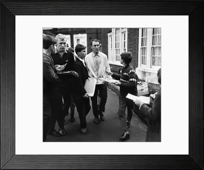 Framed Print : England footballers Bobby Moore and Jimmy Greaves are beseiged by young autograph hunters Framed Print : England footballers Bobby Moore and Jimmy Greaves are beseiged by young autograph hunters