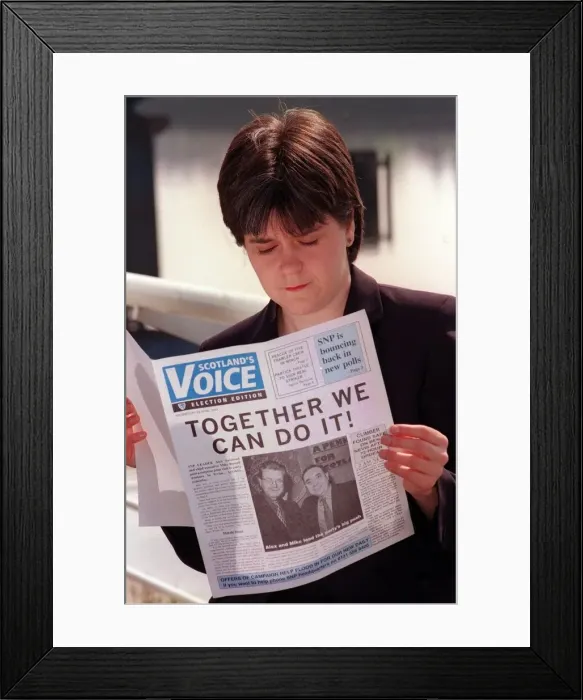 Framed Print : Nicola Sturgeon April 1999 reading a copy of Scotlands Voice newspaper