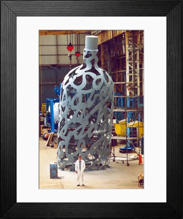 Framed Print : Yard electrician Peter Gilpin is dwarfed by the huge 35 foot metal bottle ordered by