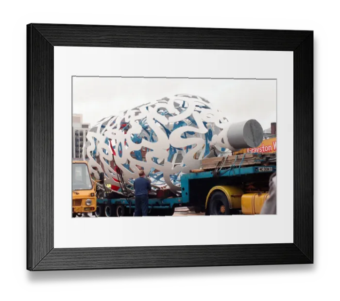 Framed Print : The sculpture Bottle of Notes is lifted off its low loader in the Central