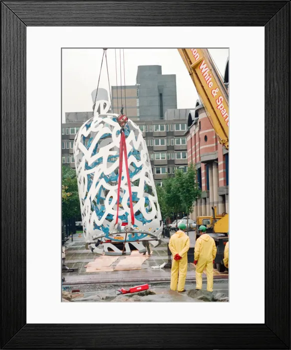 Framed Print : The sculpture Bottle of Notes is lifted off its low loader in the Central