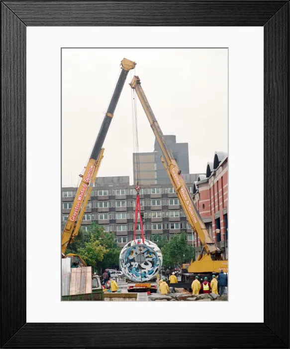 Framed Print : The sculpture Bottle of Notes is lifted off its low loader in the Central Framed Print : The sculpture Bottle of Notes is lifted off its low loader in the Central