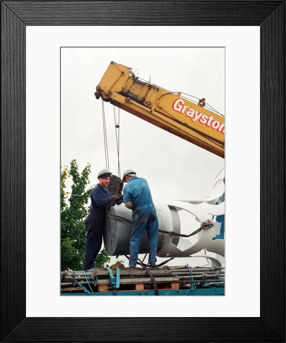Framed Print : The sculpture Bottle of Notes is lifted off its low loader in the Central