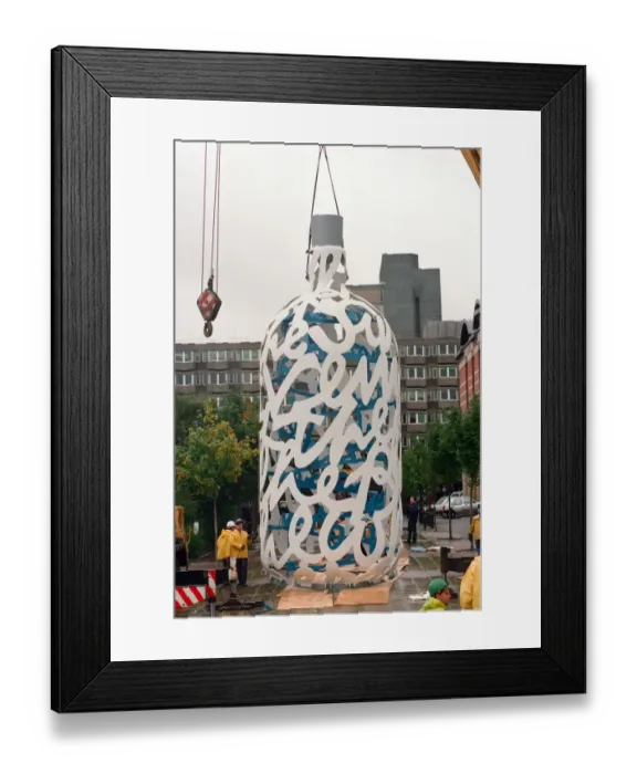 Framed Print : The sculpture Bottle of Notes is lifted off its low loader in the Central Framed Print : The sculpture Bottle of Notes is lifted off its low loader in the Central