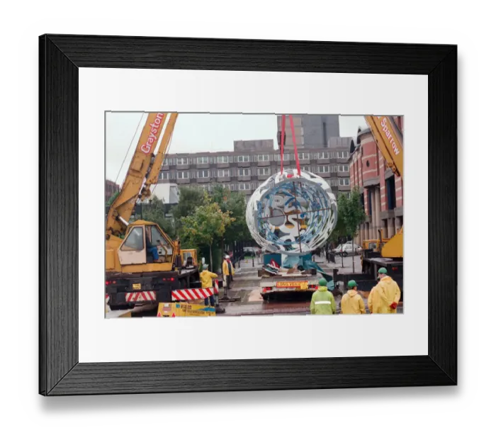 Framed Print : The sculpture Bottle of Notes is lifted off its low loader in the Central Framed Print : The sculpture Bottle of Notes is lifted off its low loader in the Central