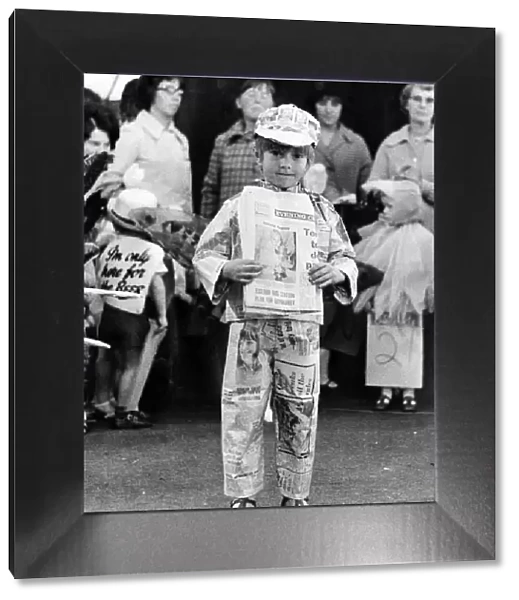 Five year old Sean, wearing a suit made of Evening Chronicle newspapers