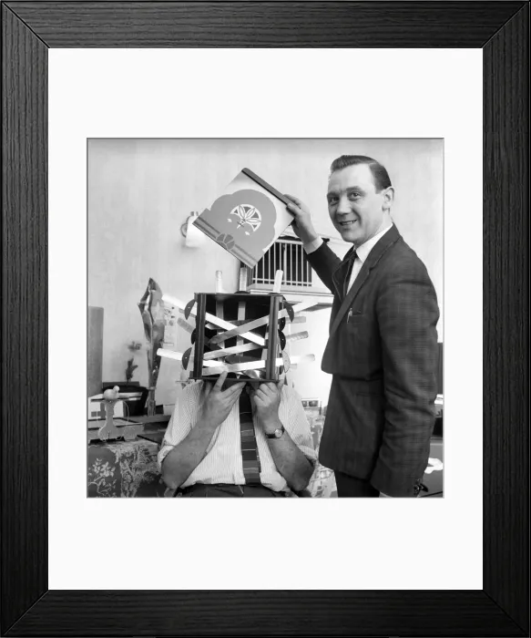 Framed Print : Magician sawing man in half also performing the swords in a box trick Framed Print : Magician sawing man in half also performing the swords in a box trick