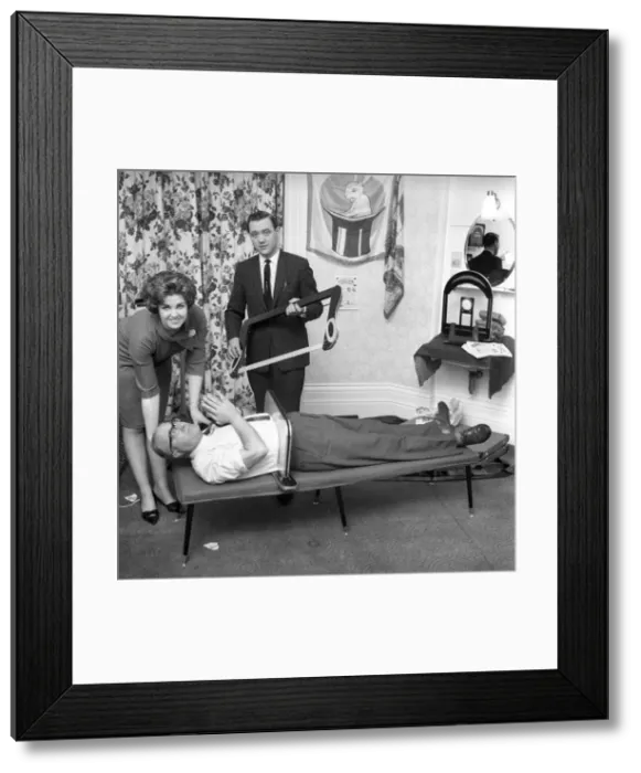 Framed Print : Magician sawing man in half also performing the swords in a box trick Framed Print : Magician sawing man in half also performing the swords in a box trick