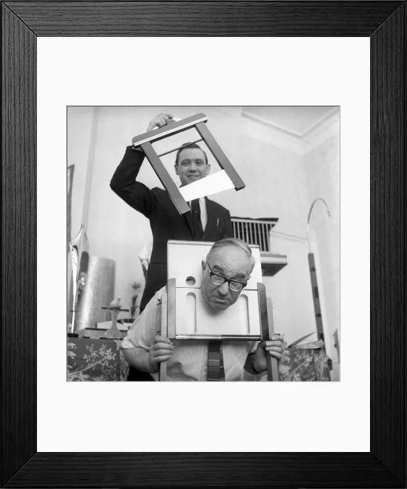 Framed Print : Magician sawing man in half also performing the swords in a box trick Framed Print : Magician sawing man in half also performing the swords in a box trick