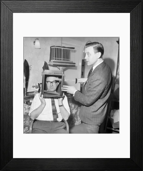 Framed Print : Magician sawing man in half also performing the swords in a box trick Framed Print : Magician sawing man in half also performing the swords in a box trick