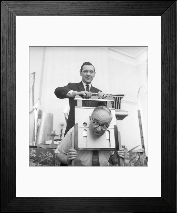 Framed Print : Magician sawing man in half also performing the swords in a box trick Framed Print : Magician sawing man in half also performing the swords in a box trick