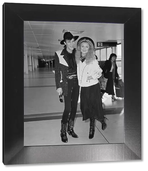 Britt Ekland with boyfriend Slim Jim McDonnell at Heathrow Airport. 16th November 1982