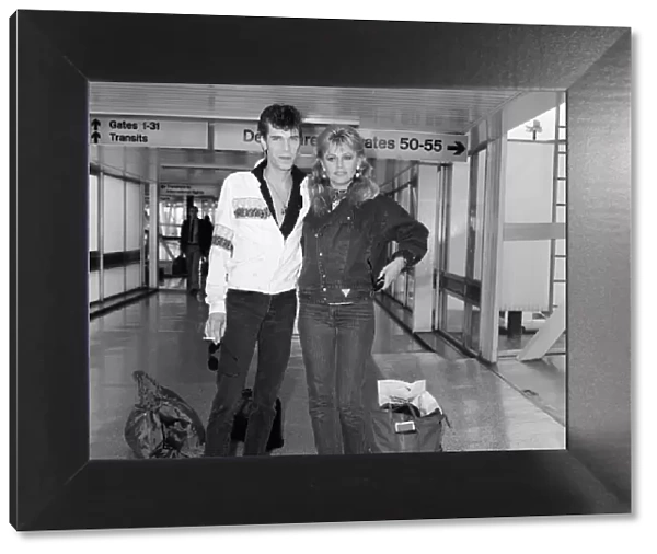 Britt Ekland with boyfriend Slim Jim McDonnell at Heathrow Airport after flying in