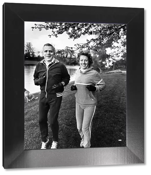 Jaguar boss Mr John Egan sets out on a morning run with his wife Julia. 23rd April 1983