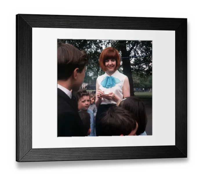 Framed Print : Cilla Black Singer TV Presenter stands signing autographs for young children Framed Print : Cilla Black Singer TV Presenter stands signing autographs for young children