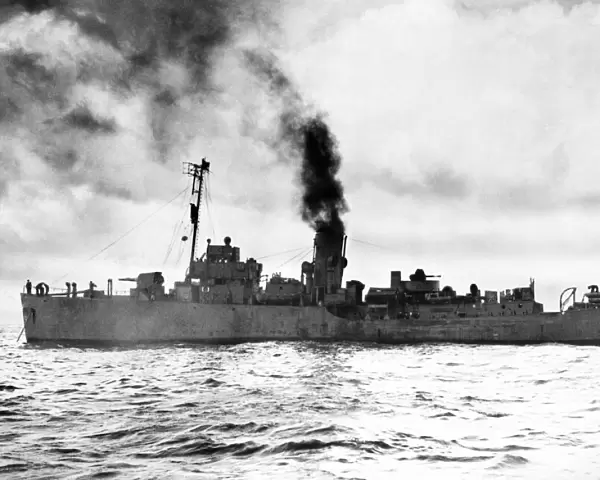 The Flower class corvette HMS Camellia (K31) getting up steam before escorting a convoy