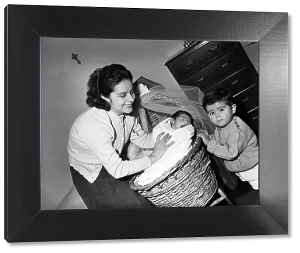 Mrs Myriam Mandragon tucks in baby Alphonse as older brother Ricardo looks