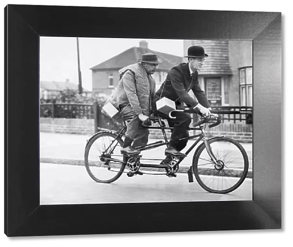 Two business men who usually travel to town by car share a tandem cycle after