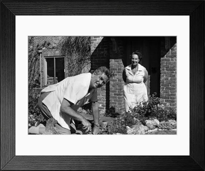 Framed Print : Denis Healey at work on a fishpond in his garden at his home in the Sussex countryside Framed Print : Denis Healey at work on a fishpond in his garden at his home in the Sussex countryside