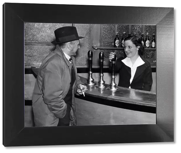 Miss Nora Collins chatting with a customer in her public house, 21st March 1938