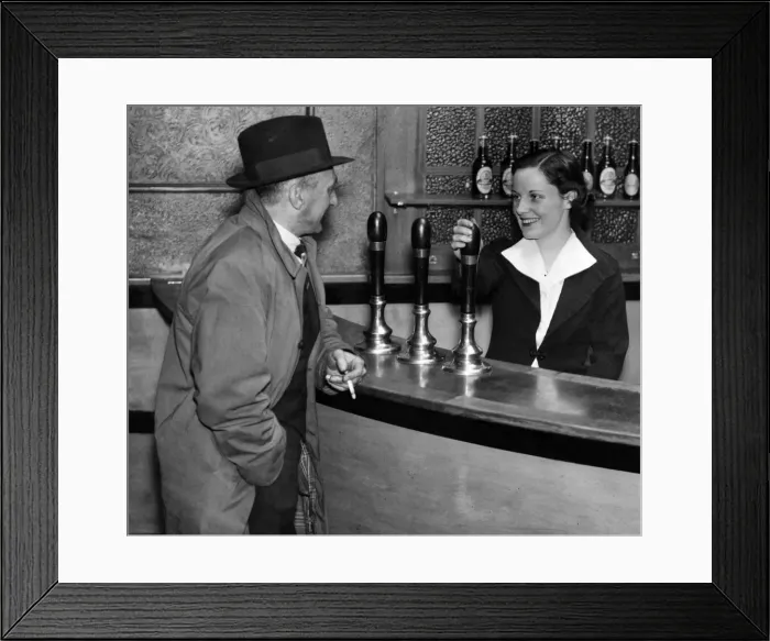 Framed Print : Miss Nora Collins chatting with a customer in her public house, 21st March 1938 Framed Print : Miss Nora Collins chatting with a customer in her public house, 21st March 1938