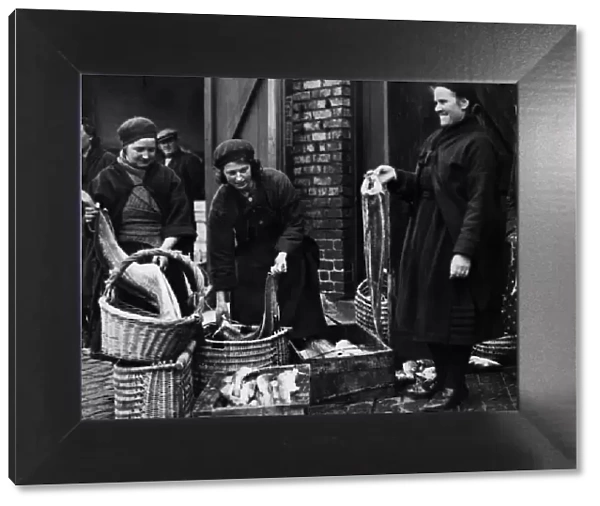 Fishwives of Cullercoats filling their creels for the days rounds at North Shields Fish