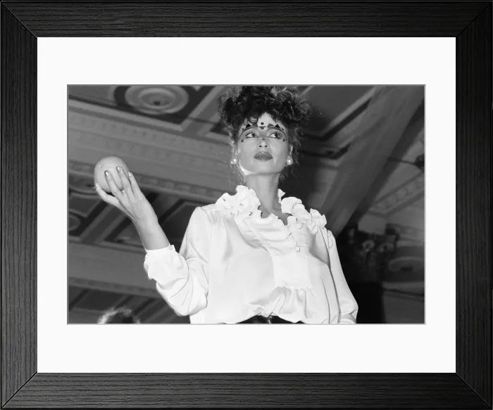 Framed Print : Zandra Rhodes Fashion Show, Olympia, London, October 1980. Model holding fruit, orange