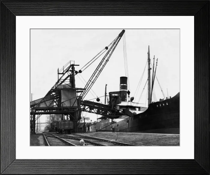 Framed Print : A ship loading anthracite coal by conveyor at the Swansea docks. Circa January 1937