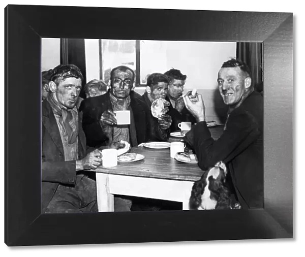 A group of miners enjoying a meal after the opening of a pithead canteen at Isabella Pit