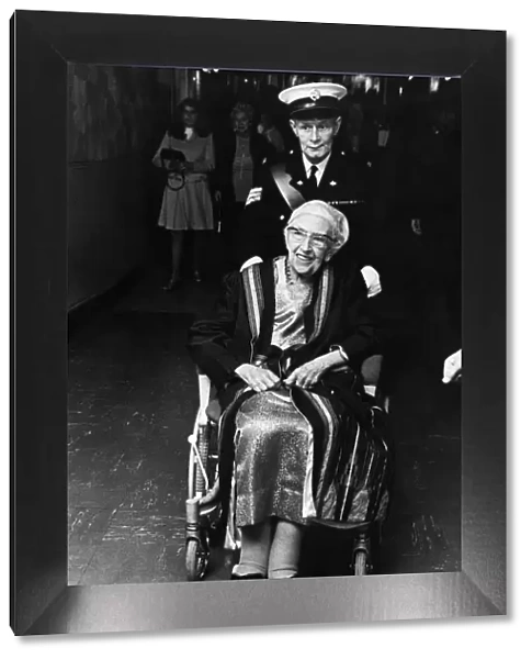British author Agatha Christie is wheeled into the Olymiua Theatre as she attends