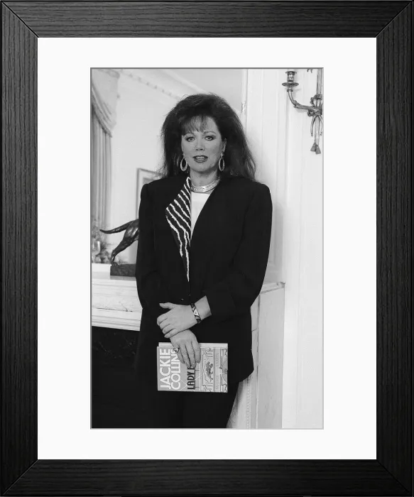 Framed Print : Jackie Collins in a London Hotel Mirrorpix with her latest novel Lady Boss