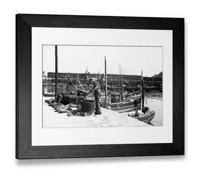 Framed Print : Fishermen prepare their nets on the East Wharf, Mevagissey July 1939