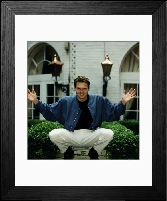 Framed Print : John Leslie TV presenter Blue Peter sitting down in garden arms out Framed Print : John Leslie TV presenter Blue Peter sitting down in garden arms out
