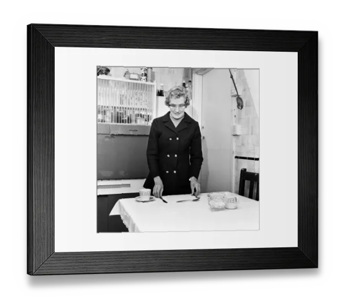 Framed Print : Mrs Mary Fullaway sets a place at her table in her Corporation house in Aycliffe Avenue