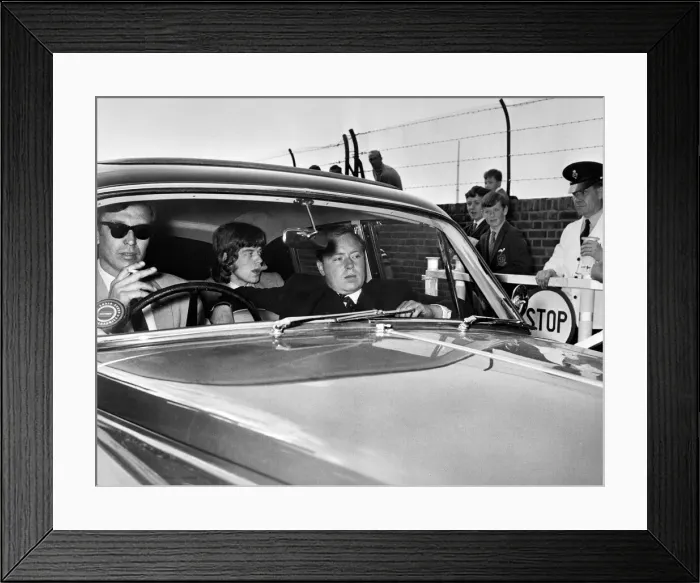 Framed Print : Mick Jagger of the Rolling Stones leaves brixton jail driving along the private road Framed Print : Mick Jagger of the Rolling Stones leaves brixton jail driving along the private road