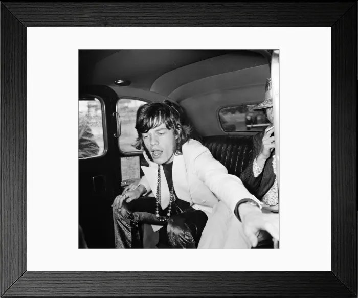 Framed Print : Rolling Stones lead singer Mick Jagger arrives at London Heathrow Airport with Marianne
