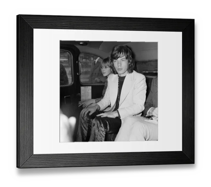 Framed Print : Rolling Stones lead singer Mick Jagger arrives at London Heathrow Airport with Marianne