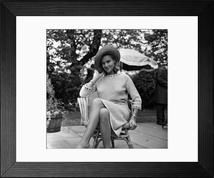 Framed Print : Actress Honor Blackman relaxes in her garden party outfit during the filming of Framed Print : Actress Honor Blackman relaxes in her garden party outfit during the filming of