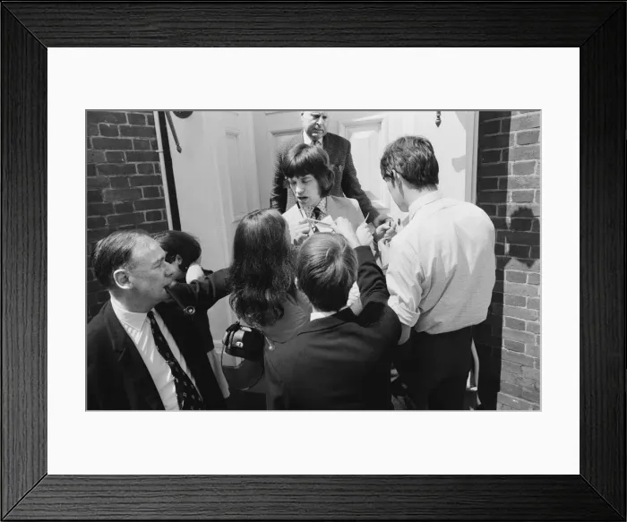 Framed Print : Mick Jagger, lead singer of the Rolling Stones pop group is surrounded by autograph
