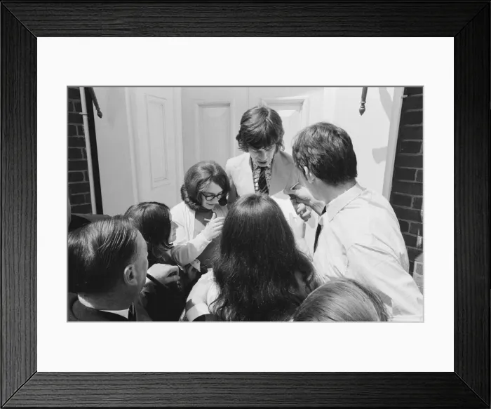 Framed Print : Mick jagger, lead singer of the Rolling Stones pop group is surrounded by autograph