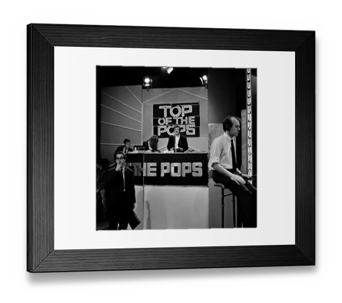 Framed Print : Alan Freeman, (black jacket, white roll neck sweater, sitting behind the microphone Framed Print : Alan Freeman, (black jacket, white roll neck sweater, sitting behind the microphone