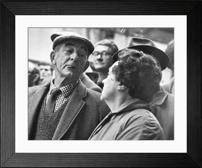 Framed Print : Rival bidders giving knowing looks to each other during the Christmas Turkey Auction