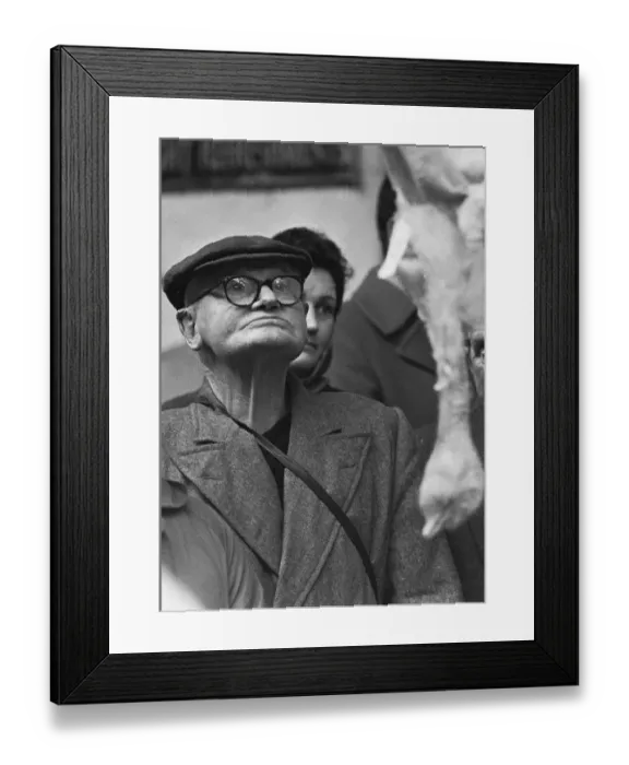 Framed Print : A potential bidder eyeing up the next bird to go under the hammer at the Christmas Turkey